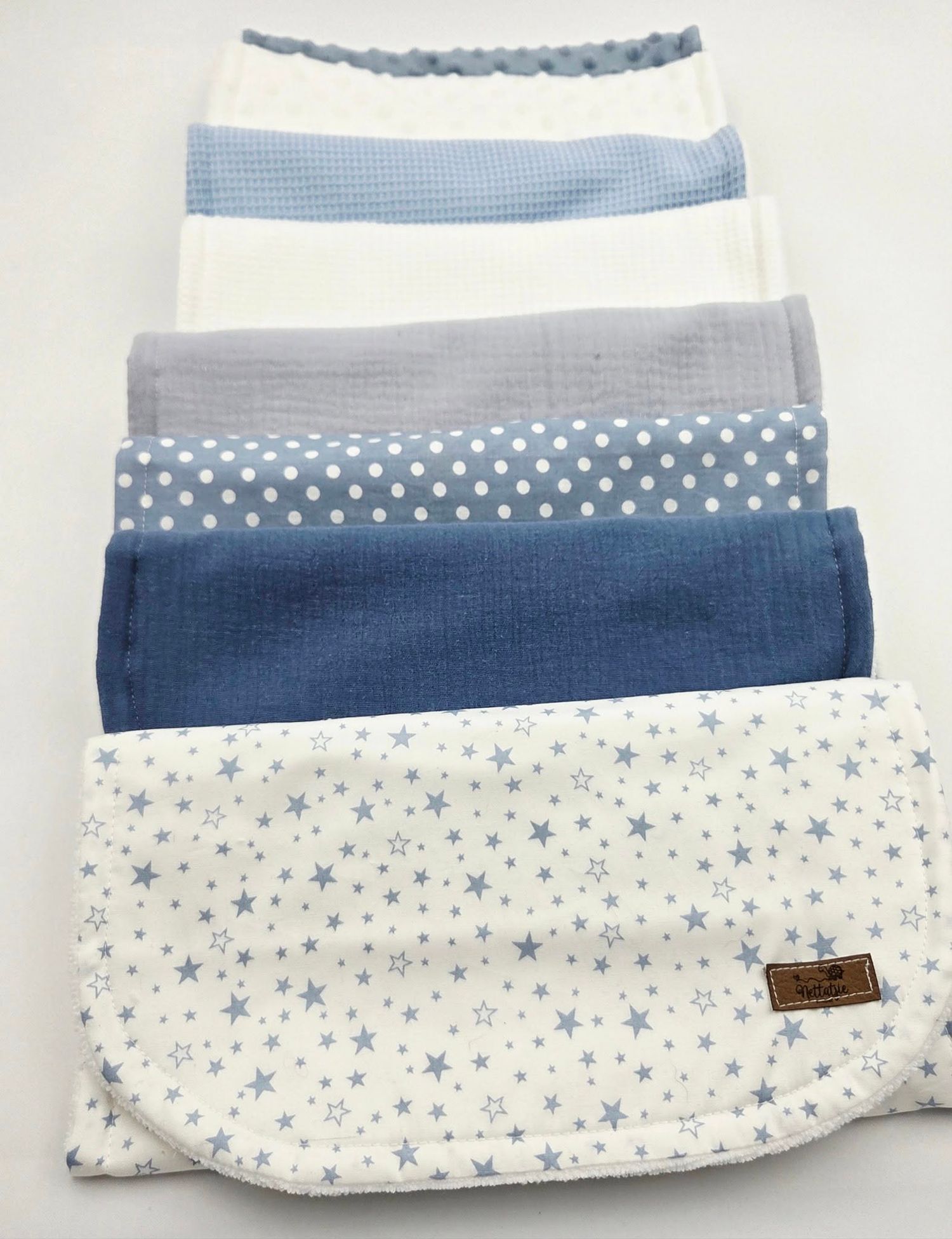Blue and white baby blanket with star pattern and ombre gradient design.