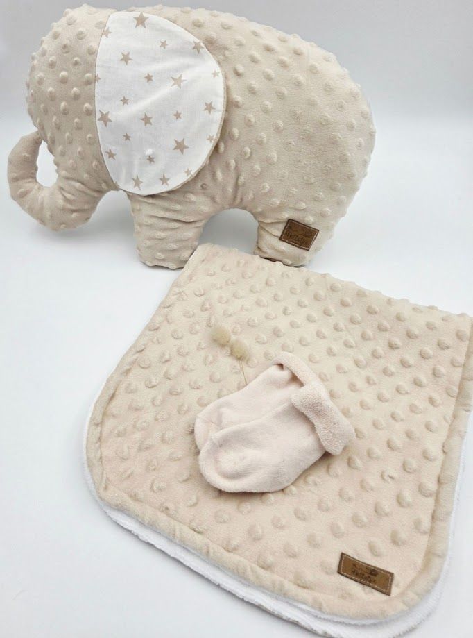 Beige minky dot elephant plush toy with star-print ears, matching blanket, and tiny baby socks set.