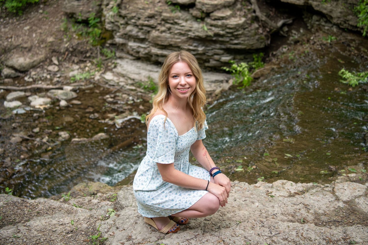 A floral dress against a natural rock formation backdrop in an outdoor setting.