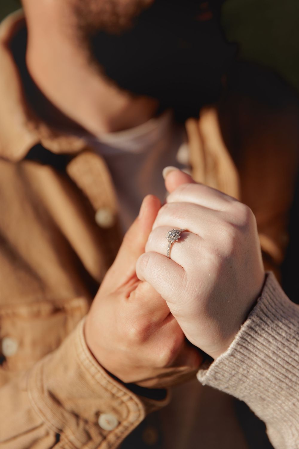 Close-up sequence of hands in a gray sweater sleeve making a fist against a dark background.