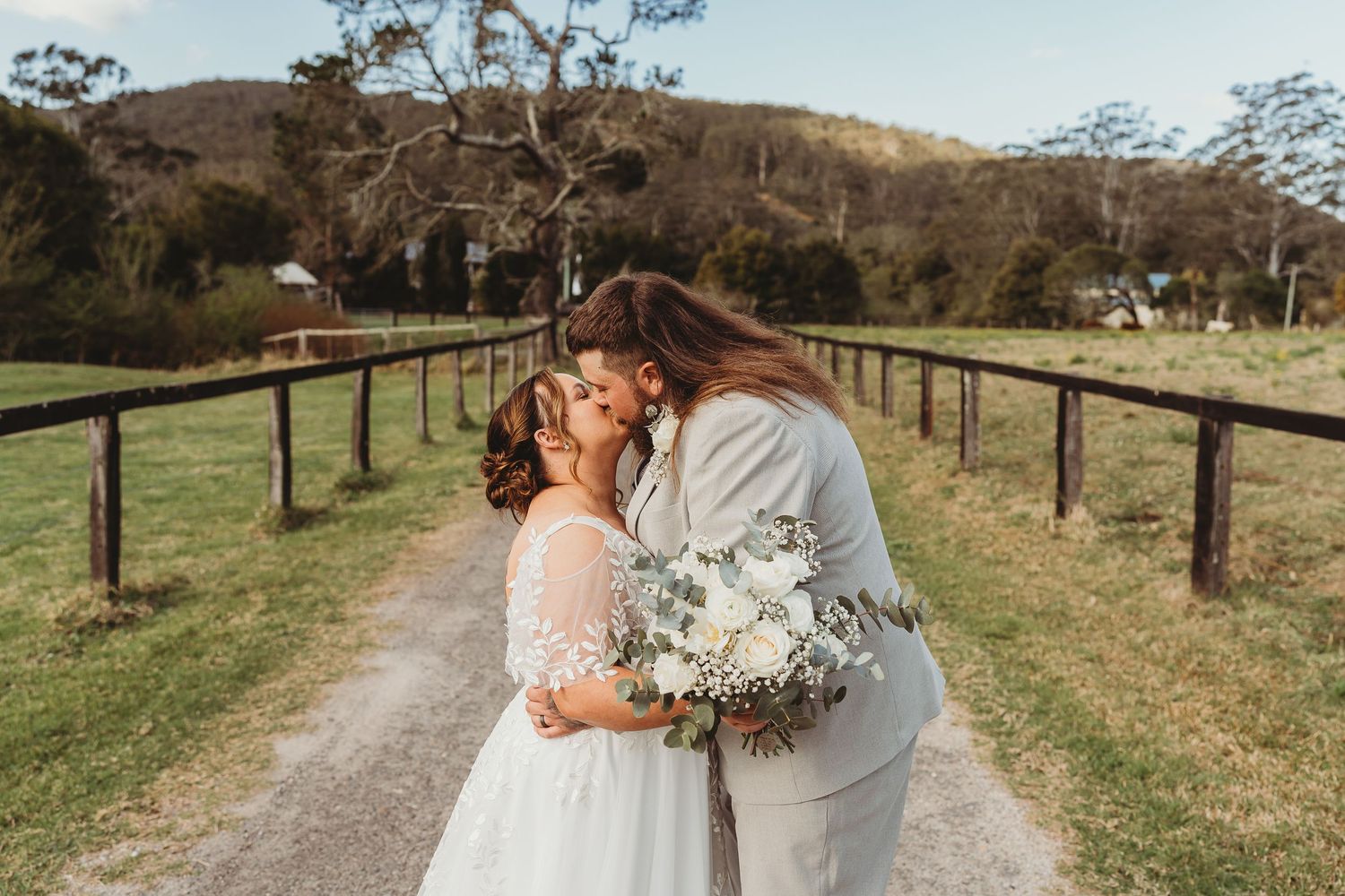 Bride and Groom kissing at Yarramalong Valley Farmstay during bridal portraits for Central Coast wedding