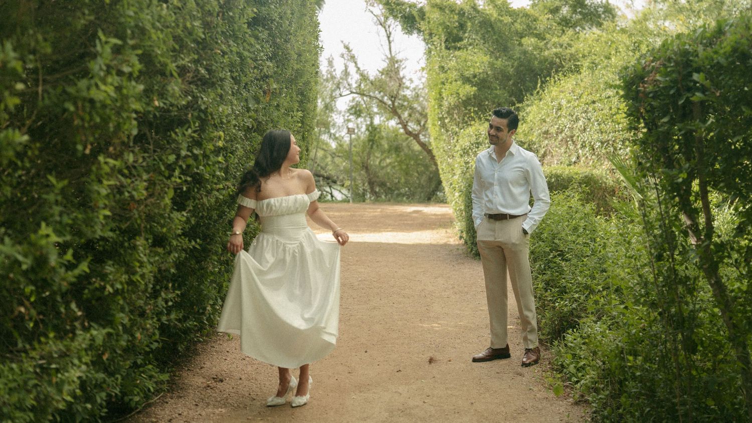 A romantic sunset wedding photo on a rolling green golf course.
