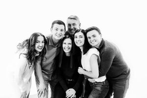 A collage of black and white photos showing people posing together in casual group shots.