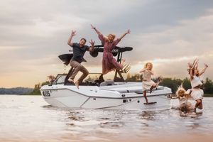 A sequence of people jumping off a boat into the water during a fun summer activity on the lake.