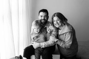 Black and white photo series showing intimate family moments with joyful expressions.