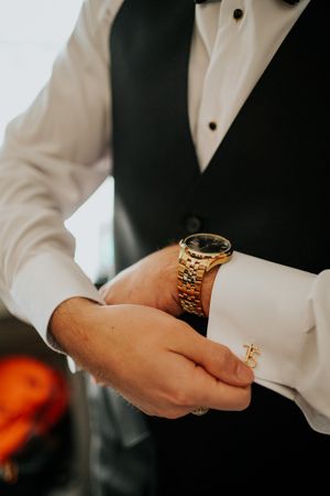 Detail shots of formal wear accessories and jewelry at a wedding.