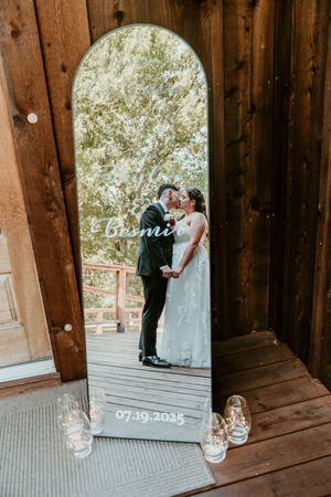 Rustic wooden covered bridge with candles creating romantic wedding day atmosphere.