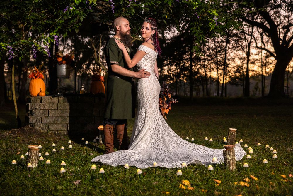 Timeless image of a couple in a creative wedding setting outside long dress mushroom field