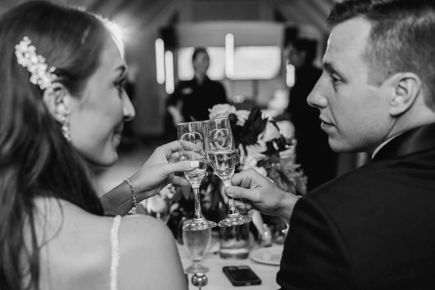 A black and white photo of a couple toasting at their wedding reception. Pittsburgh Wedding Photographer