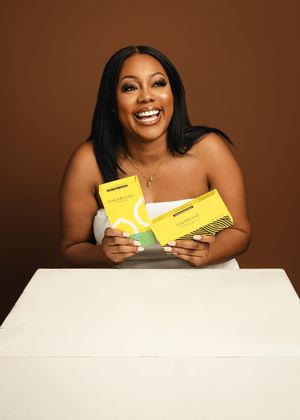 Cheerful lifestyle photo showing products against brown background with white table. at Vanessa Charlotte Photography studio