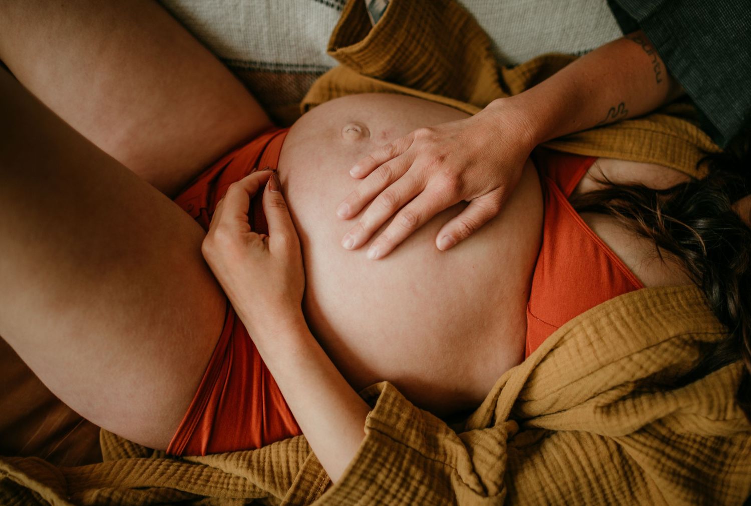 detail shot of hands touching pregnant belly portland oregon rushes & waves maternity photography