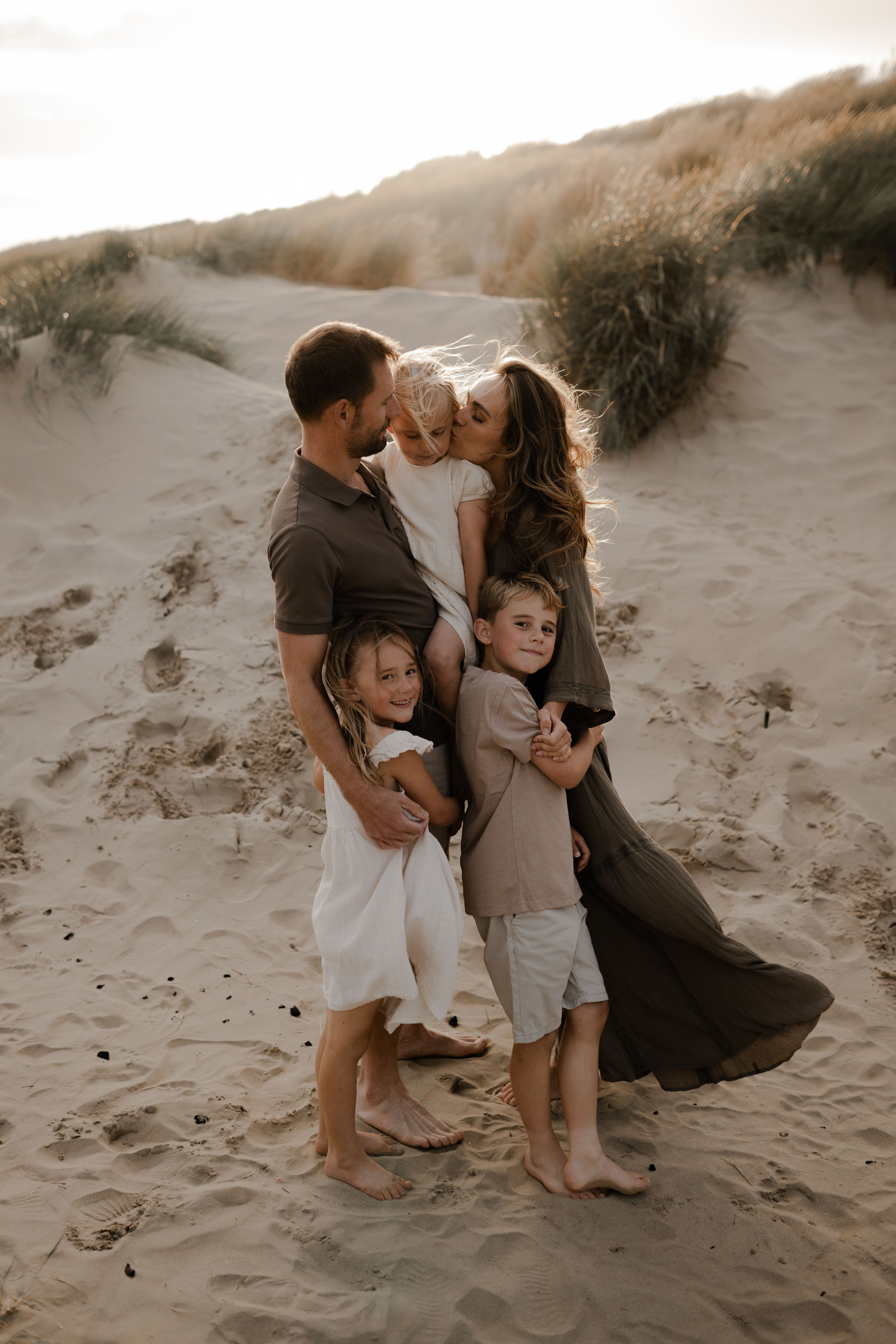 a family interacting tenderly during a photo session in Kent