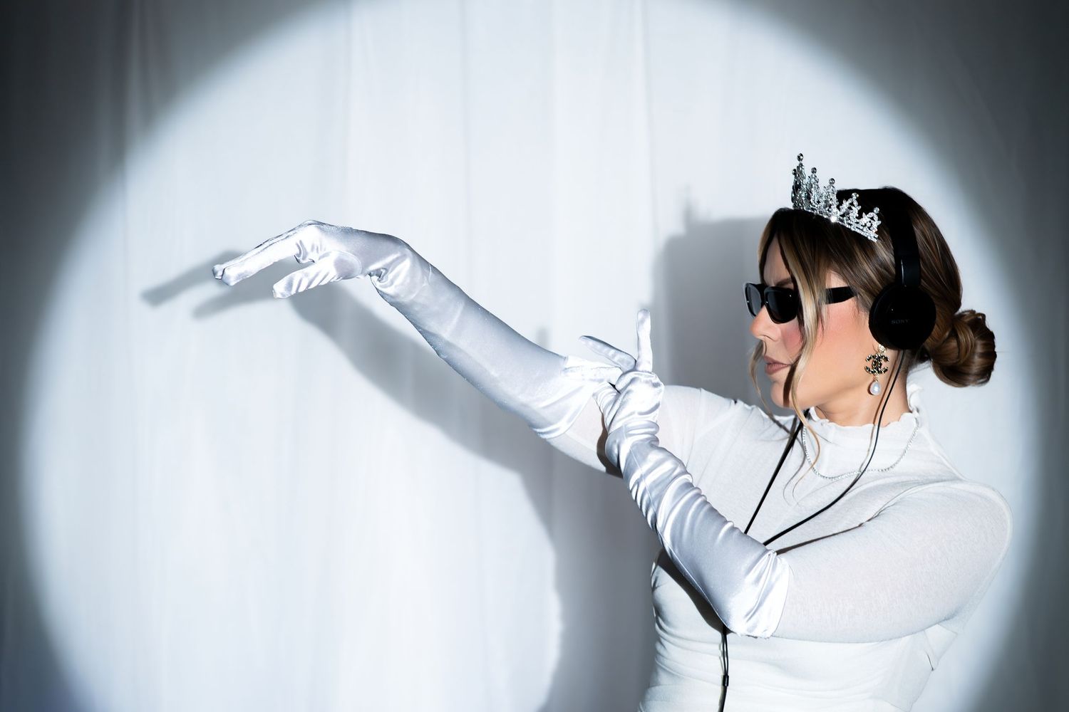 Artistic sequence of a person in white clothing performing expressive dance movements against a light background.