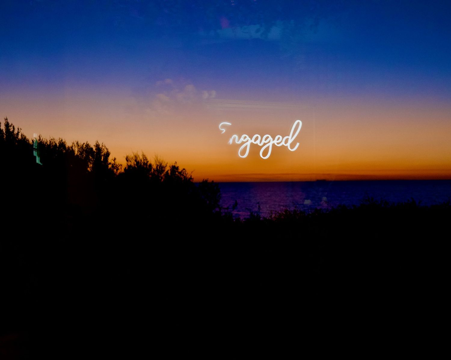 Engaged reflection from window at engagement party