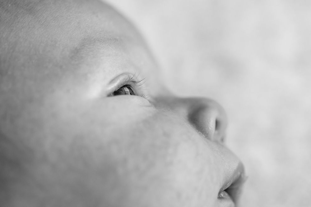 Artistic macro close-up of infant features in soft lighting.