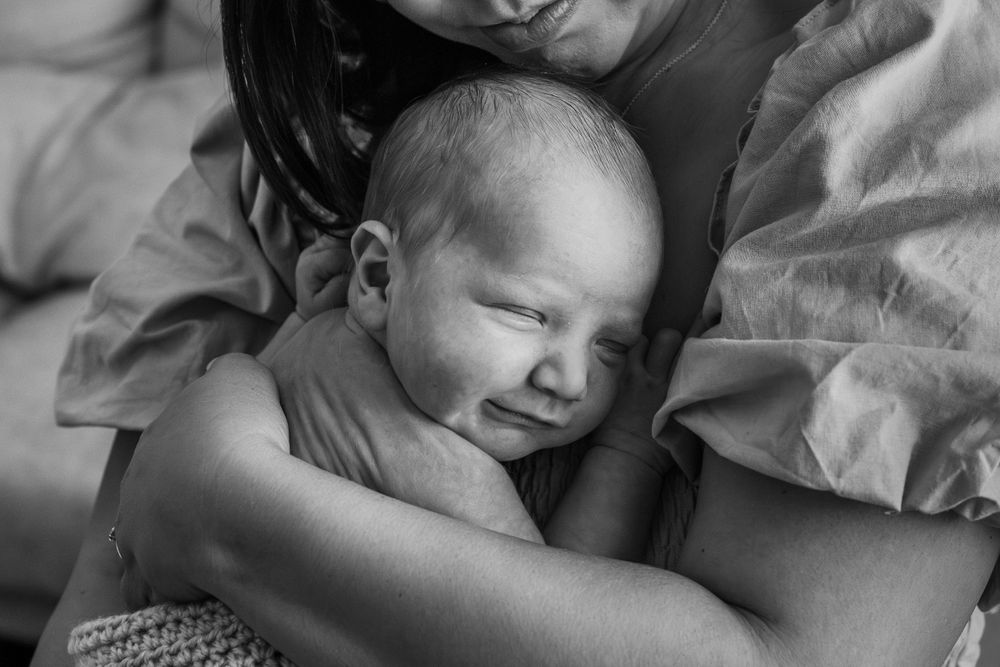 Serene black and white portrait of a sleeping newborn baby.