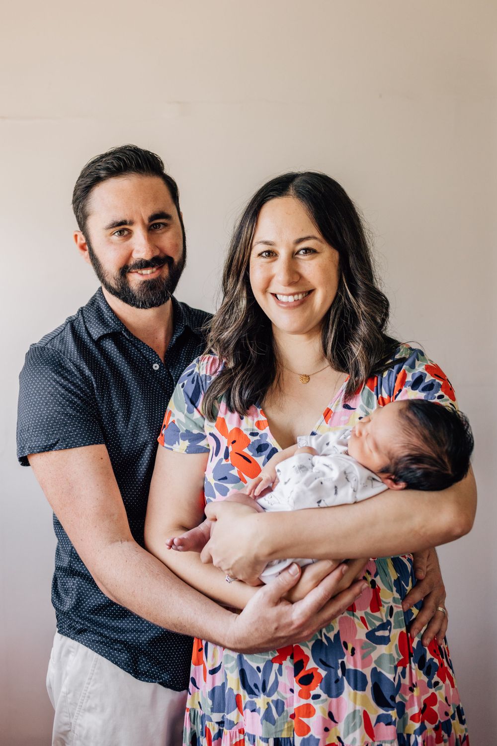 Candid family photography session showing joyful moments with a newborn baby.