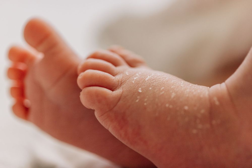 Close-up macro shot of newborn baby feet showing delicate skin texture.
