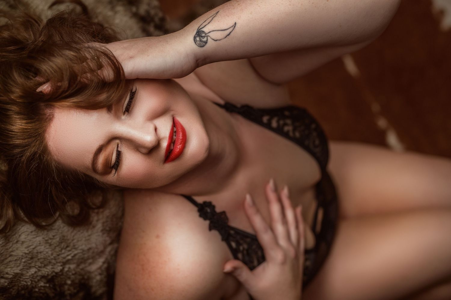 Close-up boudoir portrait featuring classic red lipstick and black lace details.