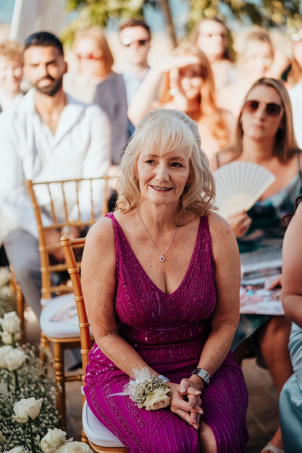 A series of photos showing a guest in a purple dress enjoying a wedding reception outdoors.
