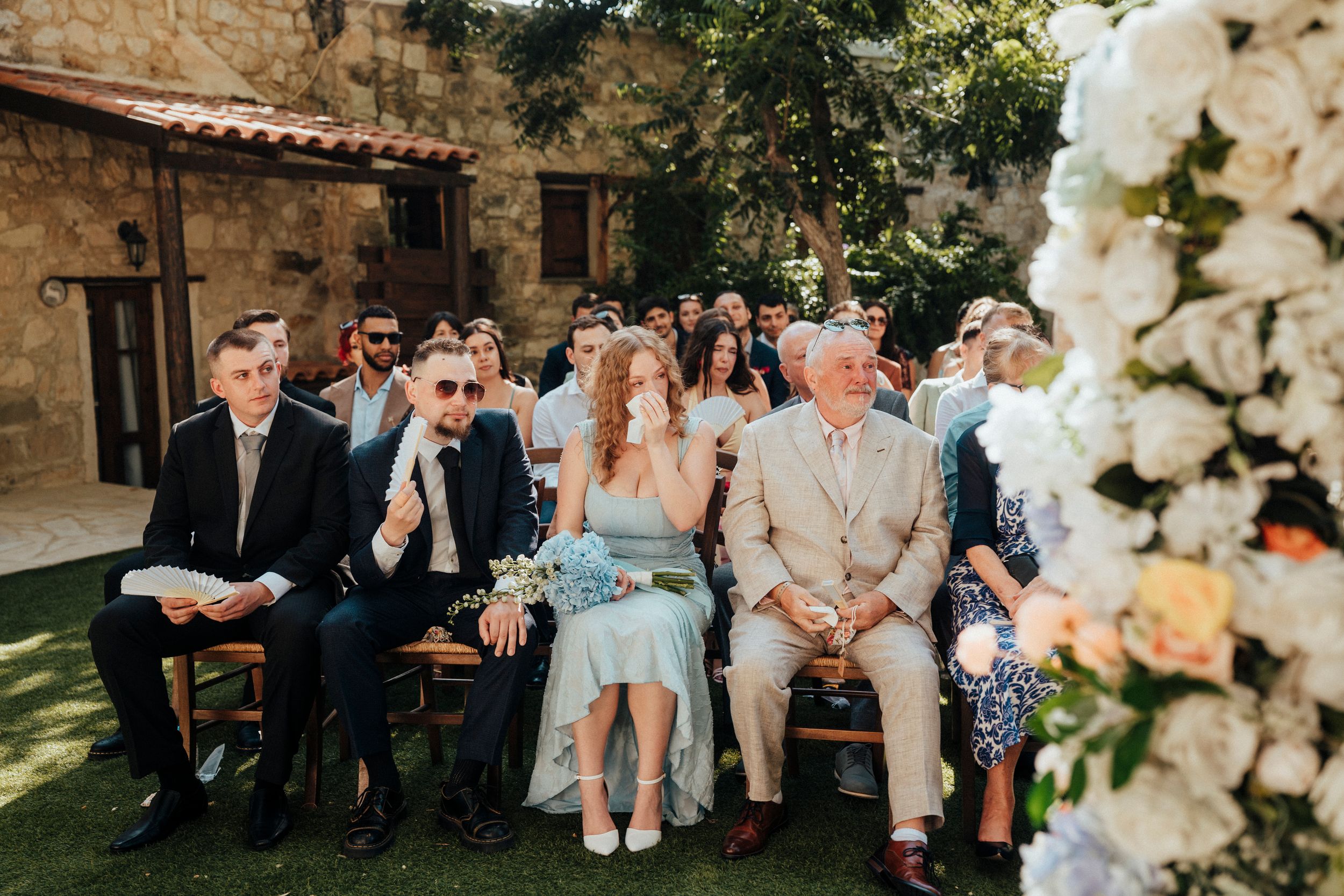 A series of wedding celebration photos showing guests enjoying an outdoor reception with floral decorations.