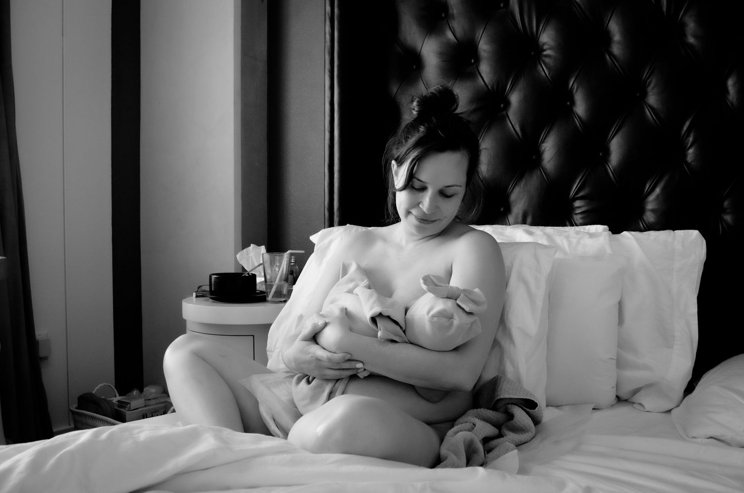 Intimate lifestyle photography session on dark tufted backdrop. Lifestyle newborn photoshoot in Las Vegas. Lifestyle Newborn photography.