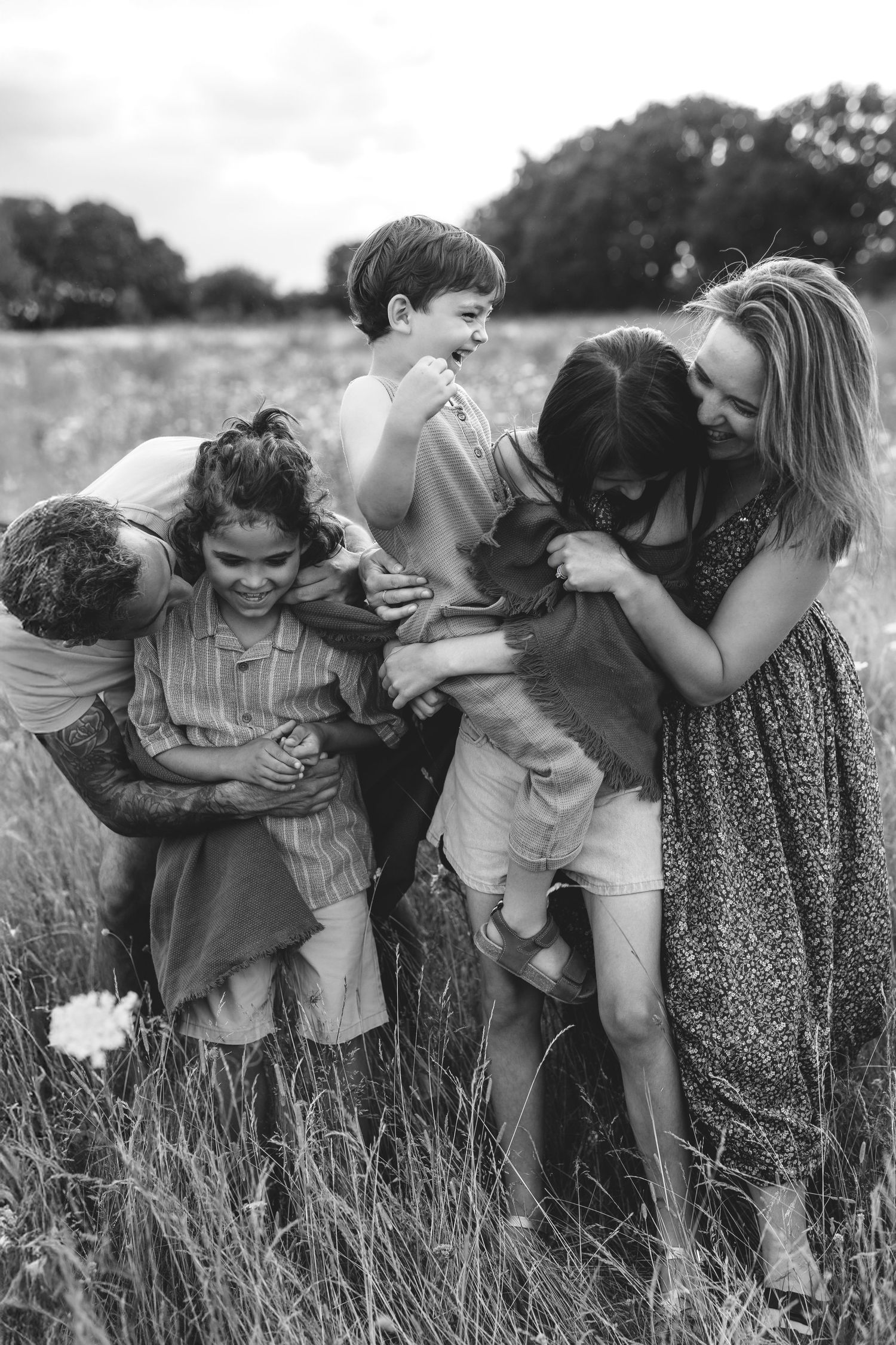 Candid moment of family playing together during location shoot.