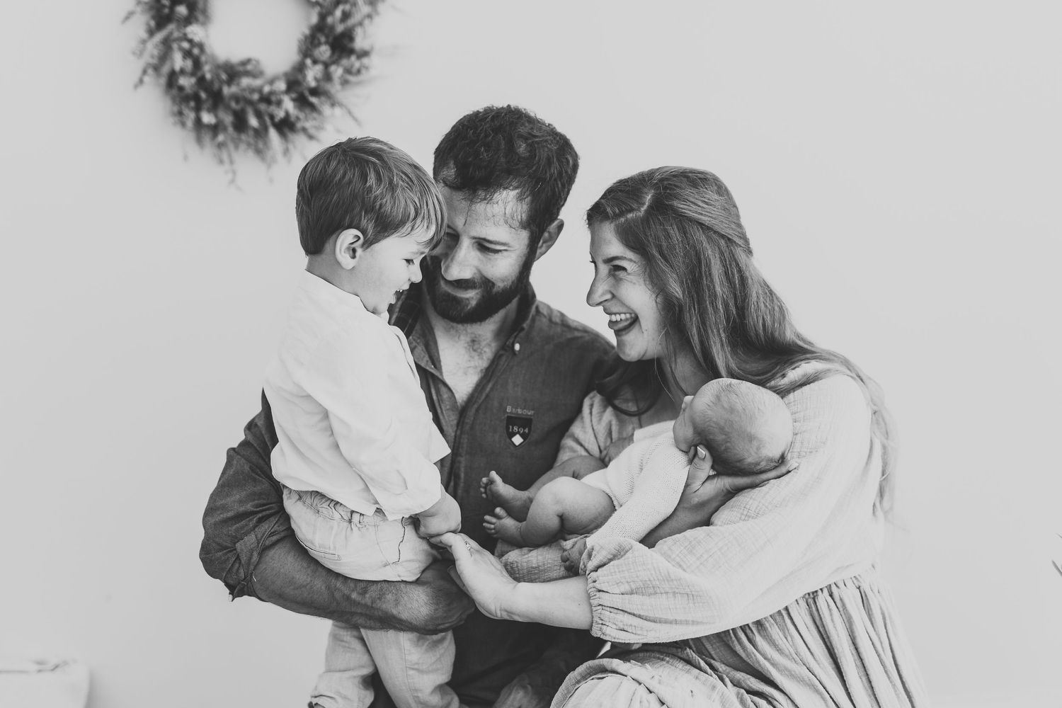 Magical family of four in light and natural photography studio