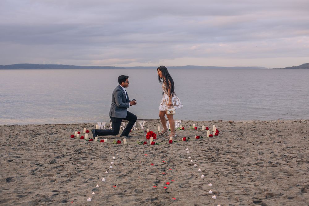 Beach proposal scene with candles arranged in heart shape at sunset. Fedore Photography Spokane Liberty Lake Photographer Senior