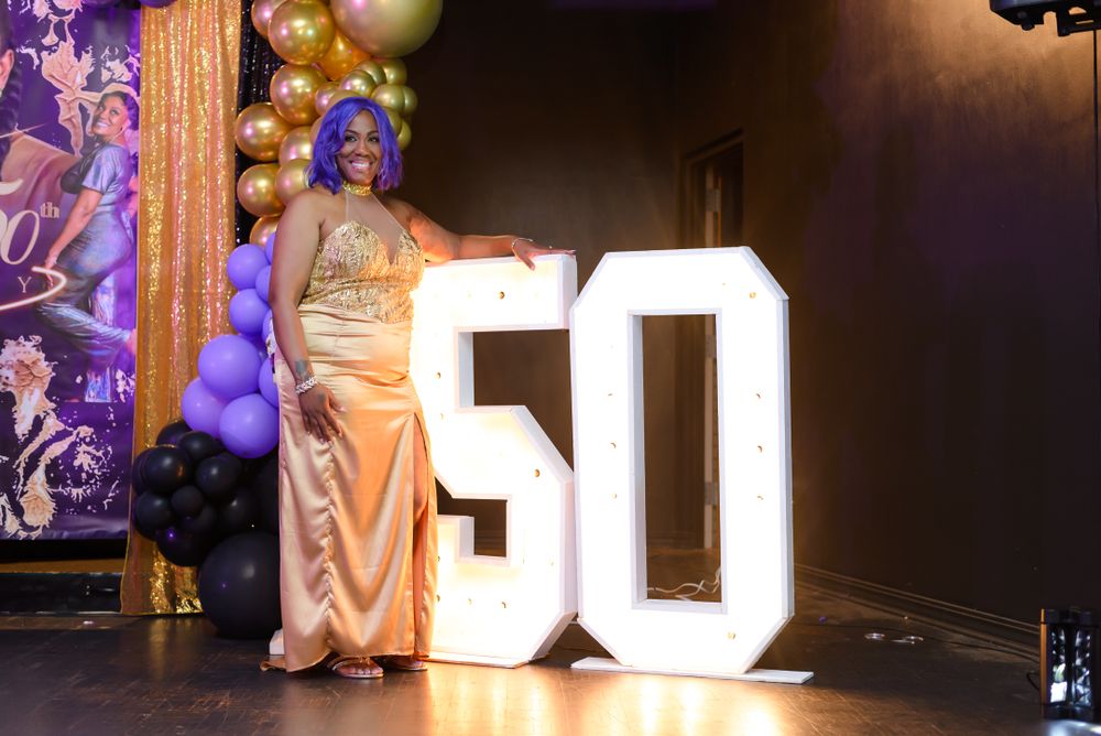 Event venue with illuminated numbers and purple accent lighting creating an elegant atmosphere.