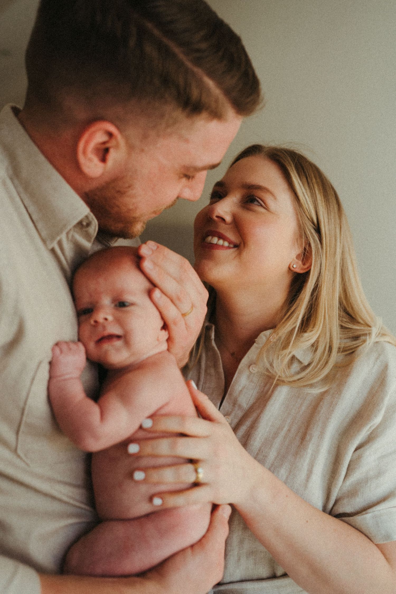Candid family moments showing joy and connection with a newborn baby.