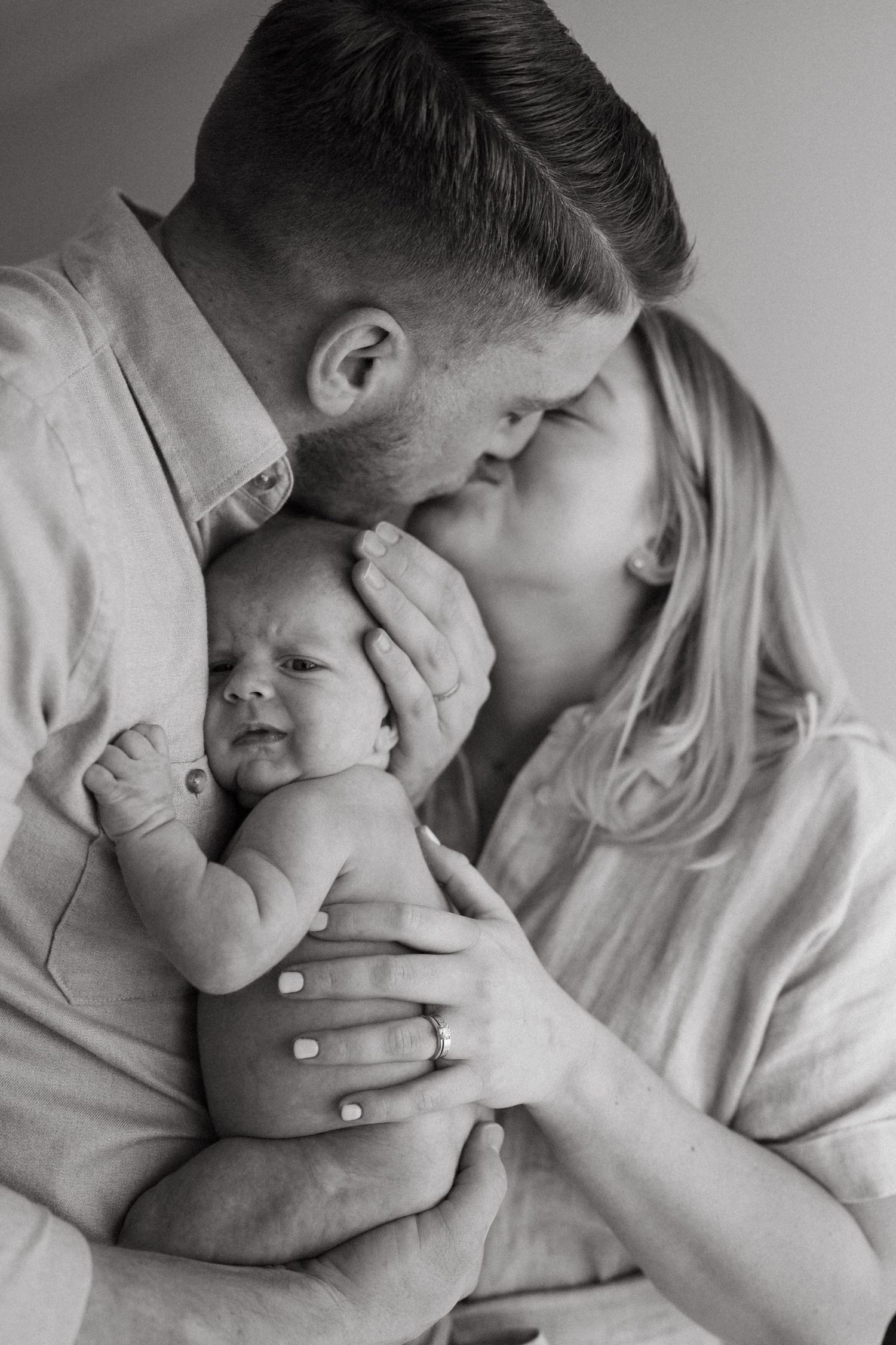 Monochrome series of intimate family portraits showing gentle embraces.