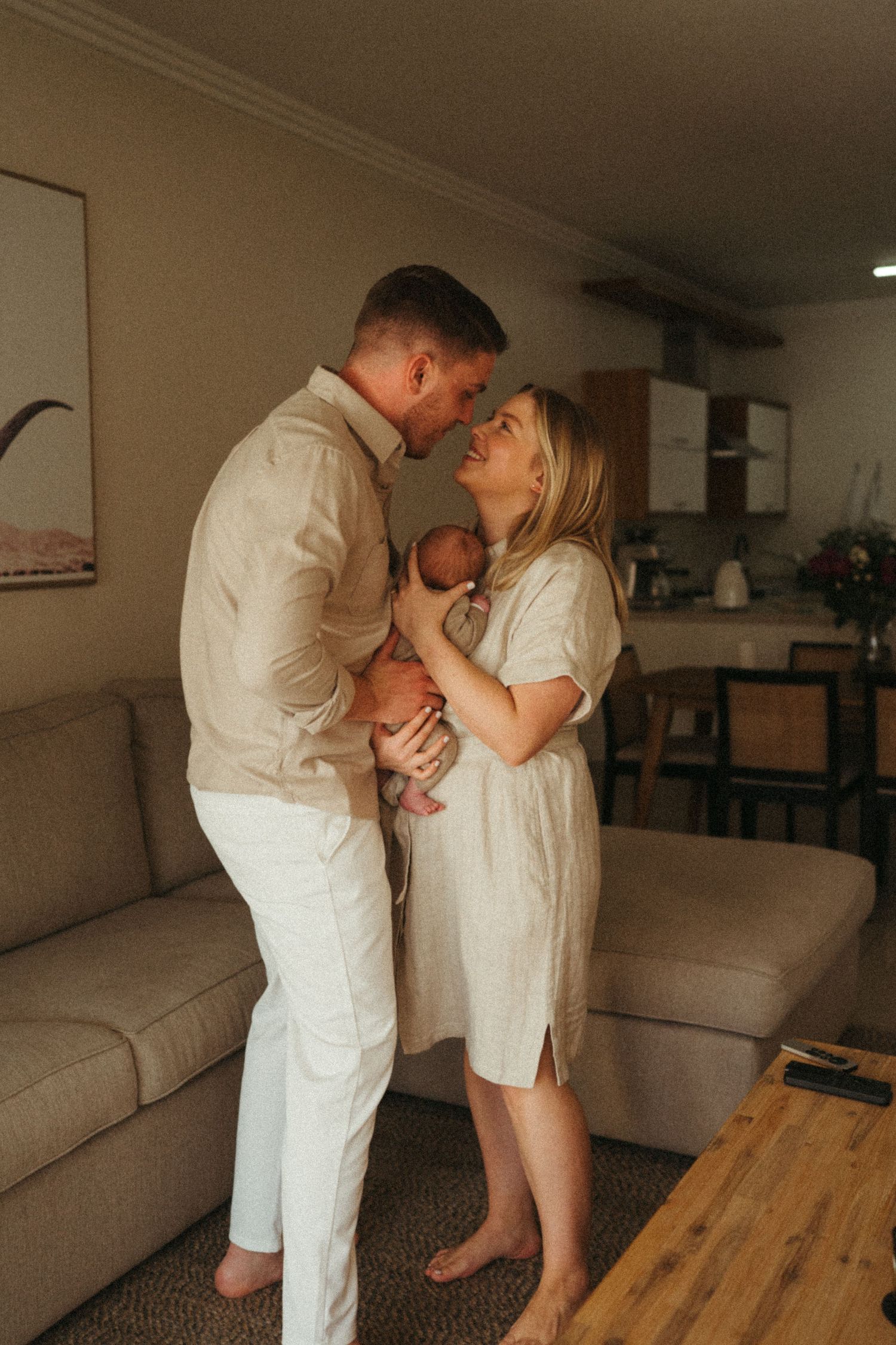 Warm family portrait series showing tender moments between loved ones in a cozy home setting.