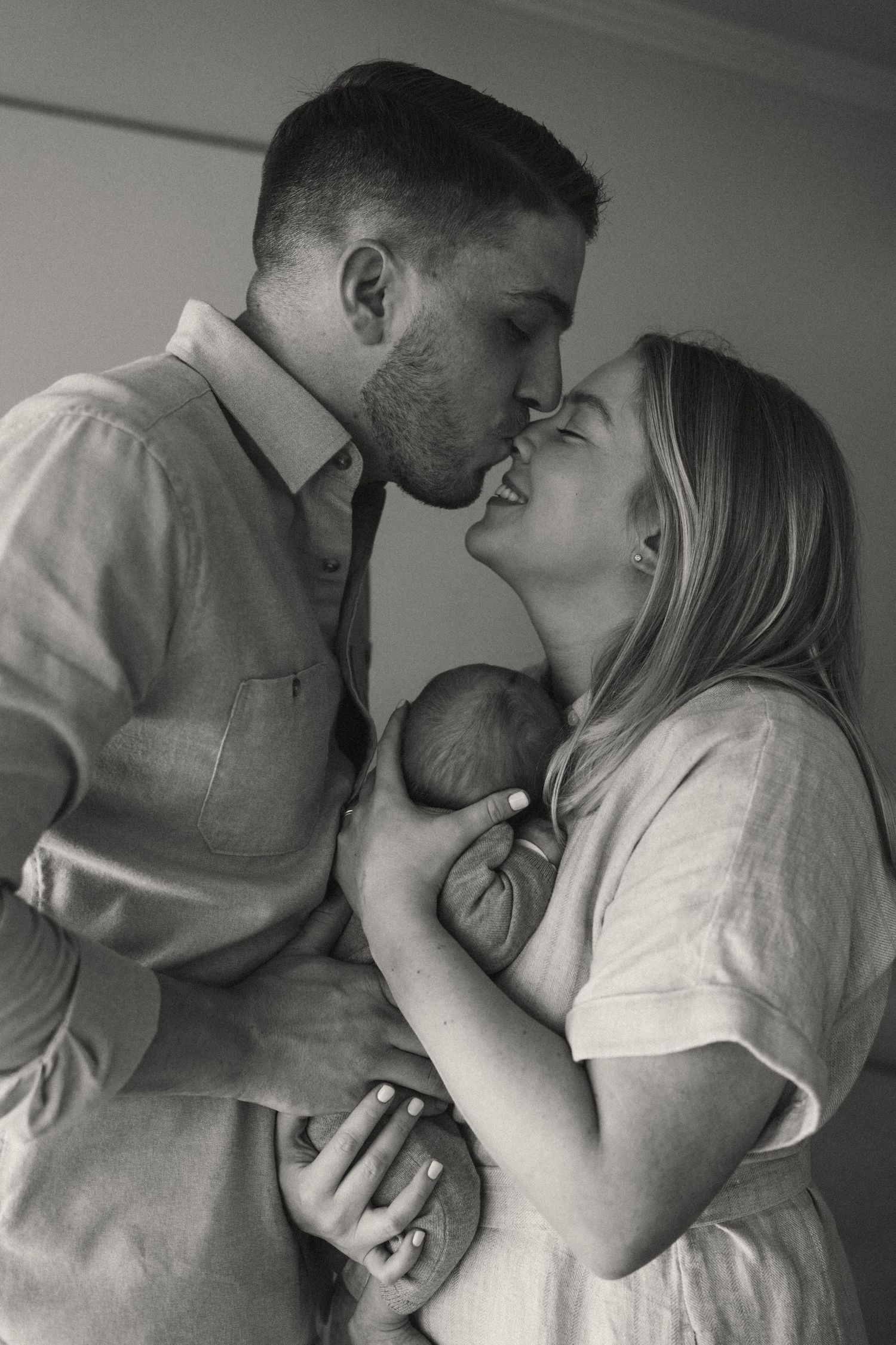 Emotional black and white photo sequence showing tender family interactions in a living room.