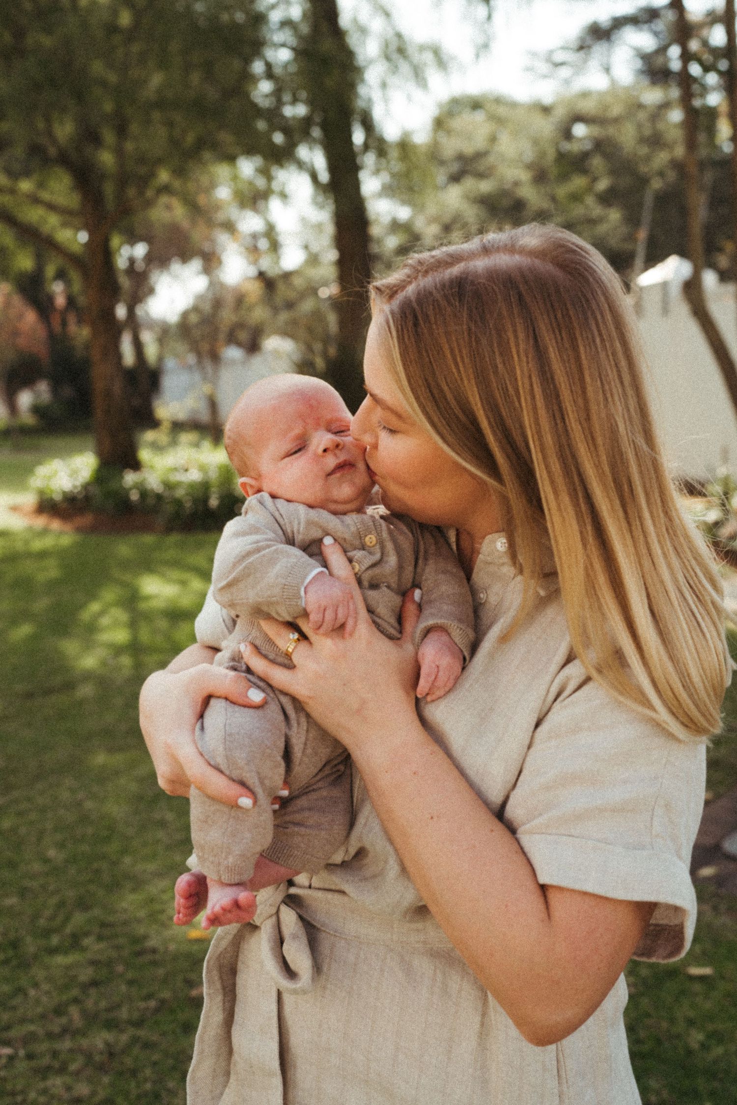 Tender family moment captured in a series of outdoor photos with warm lighting.