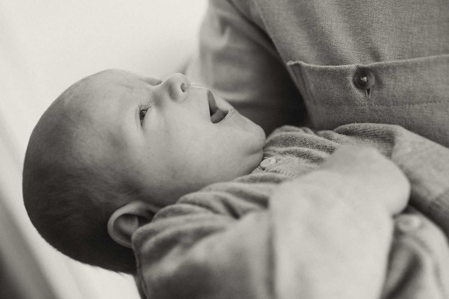 Close-up of a sleeping newborn baby in soft natural light.