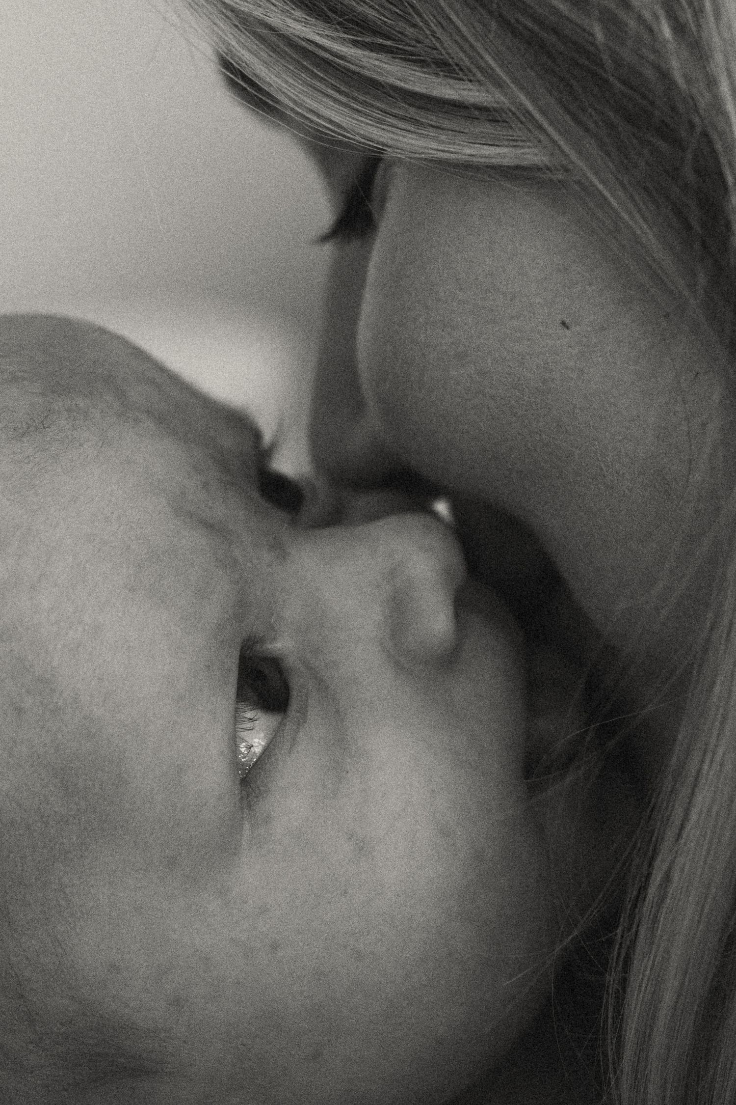 Intimate black and white close-up portrait showing gentle affection.