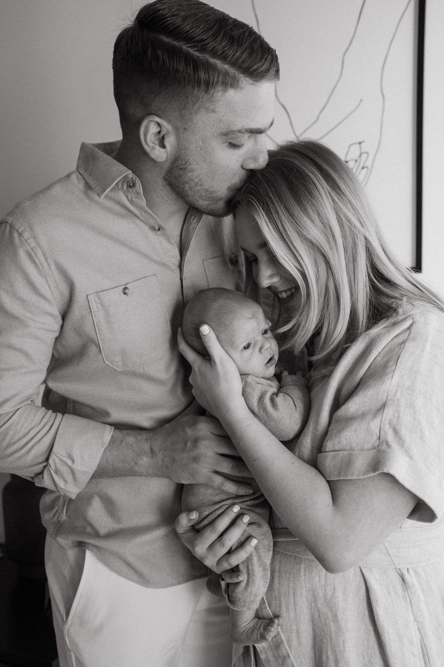 Loving family portrait series showing tender moments in soft natural light.