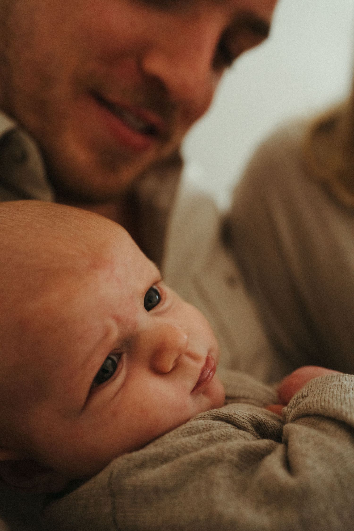 Close-up portrait capturing intimate family bonding moments in warm tones.