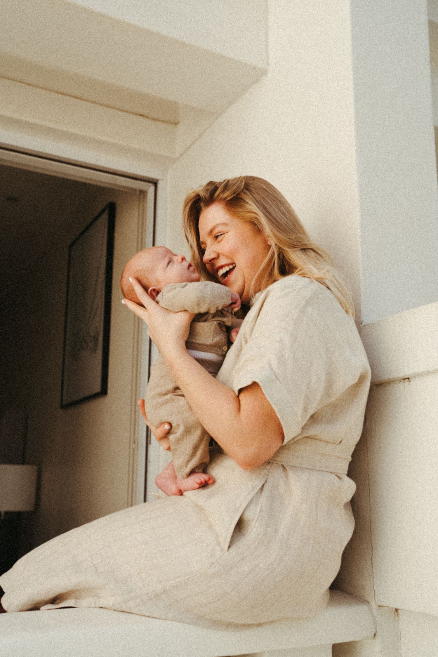 Warm natural light illuminates a gentle parenting moment.