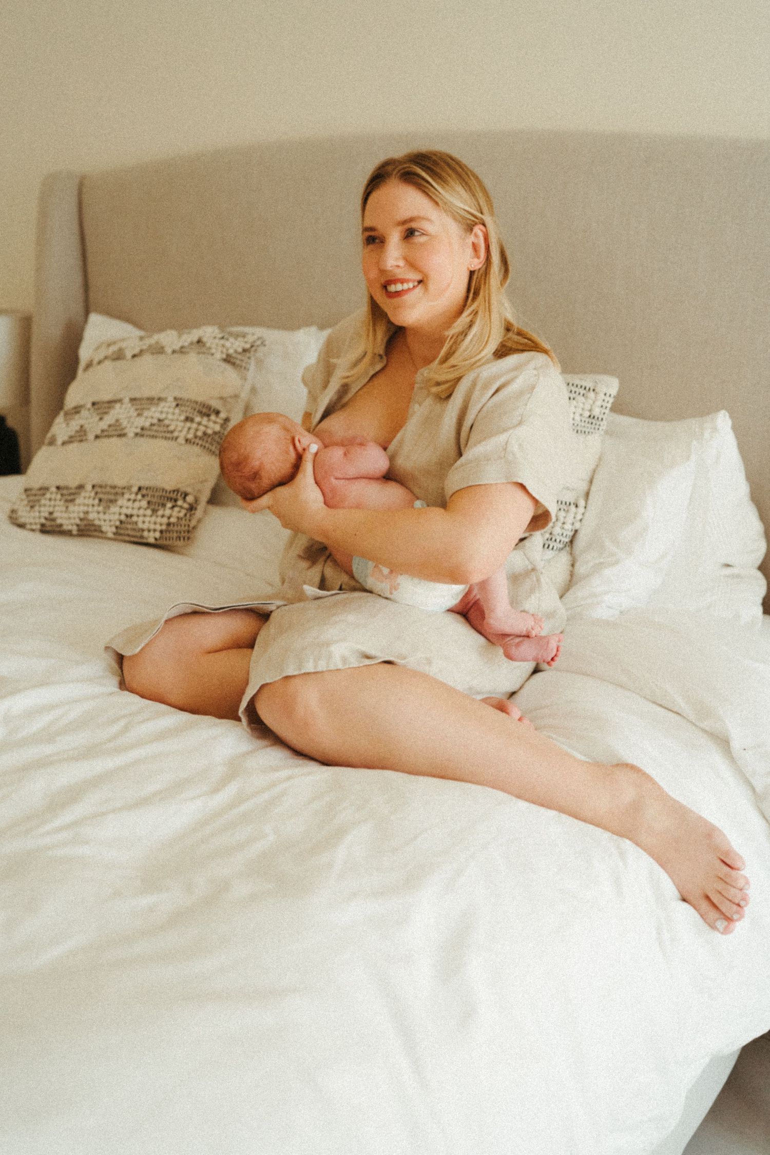 Natural light photography of quiet bonding time with newborn.