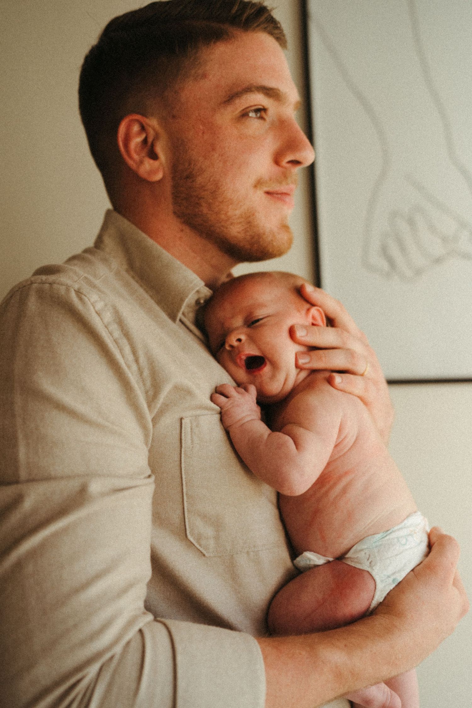 Series of photographs showing tender moments between an adult in white and a newborn baby.