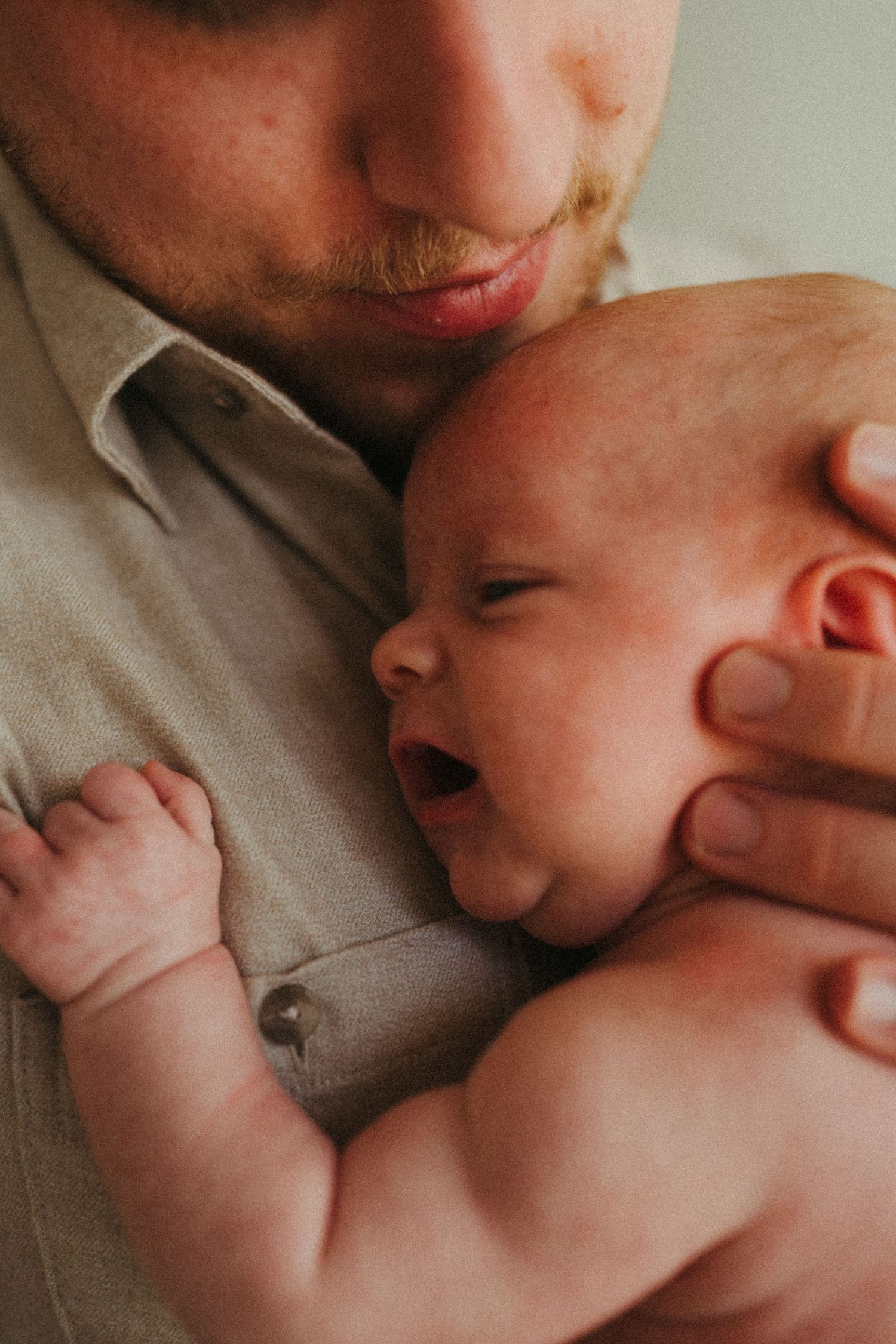 Warm toned photographs showing tender moments between caregiver and infant.