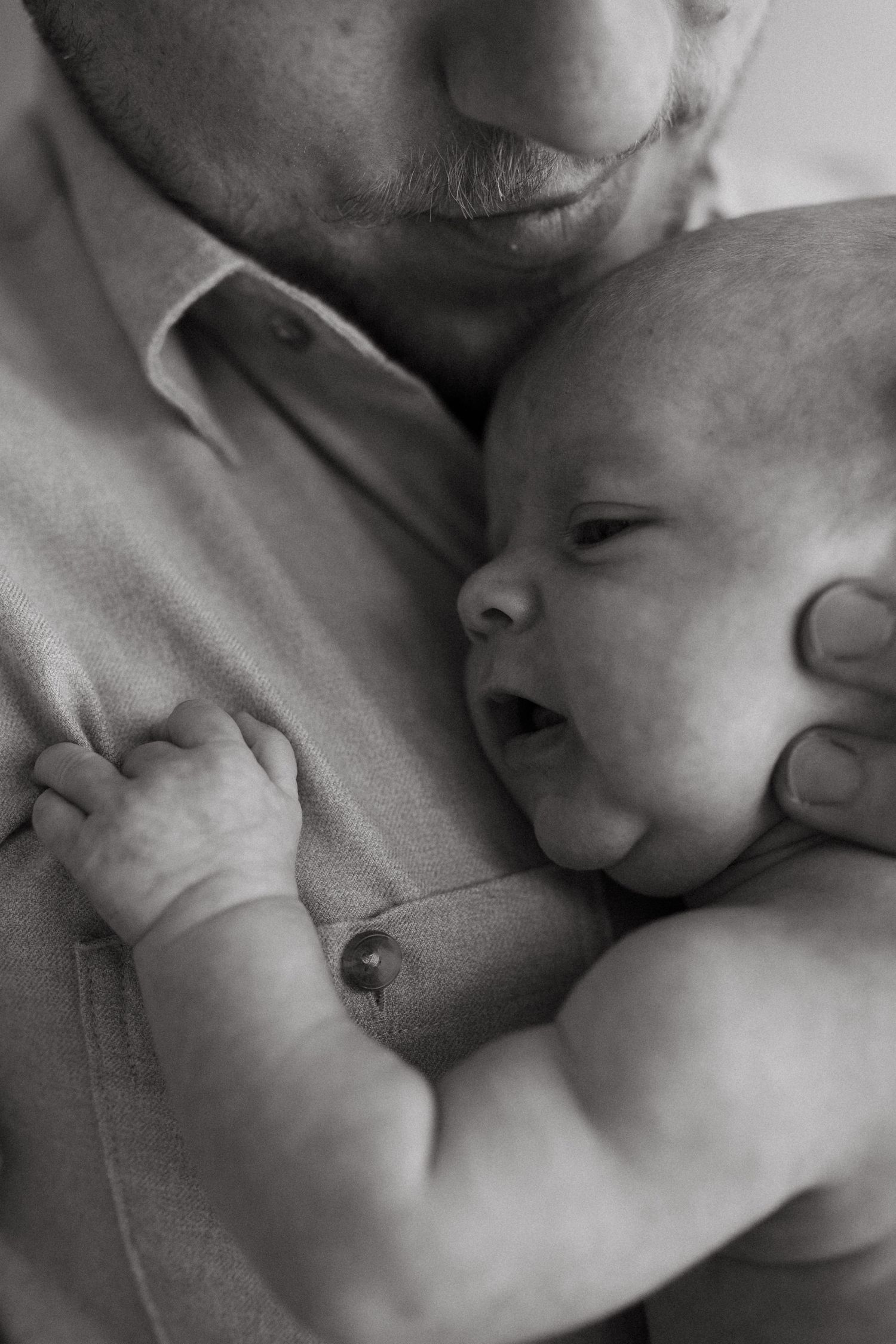 Black and white photo series capturing intimate moments with a small infant.