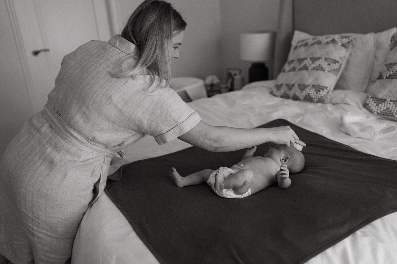 Black and white photographs showing a nursery setting with baby items.