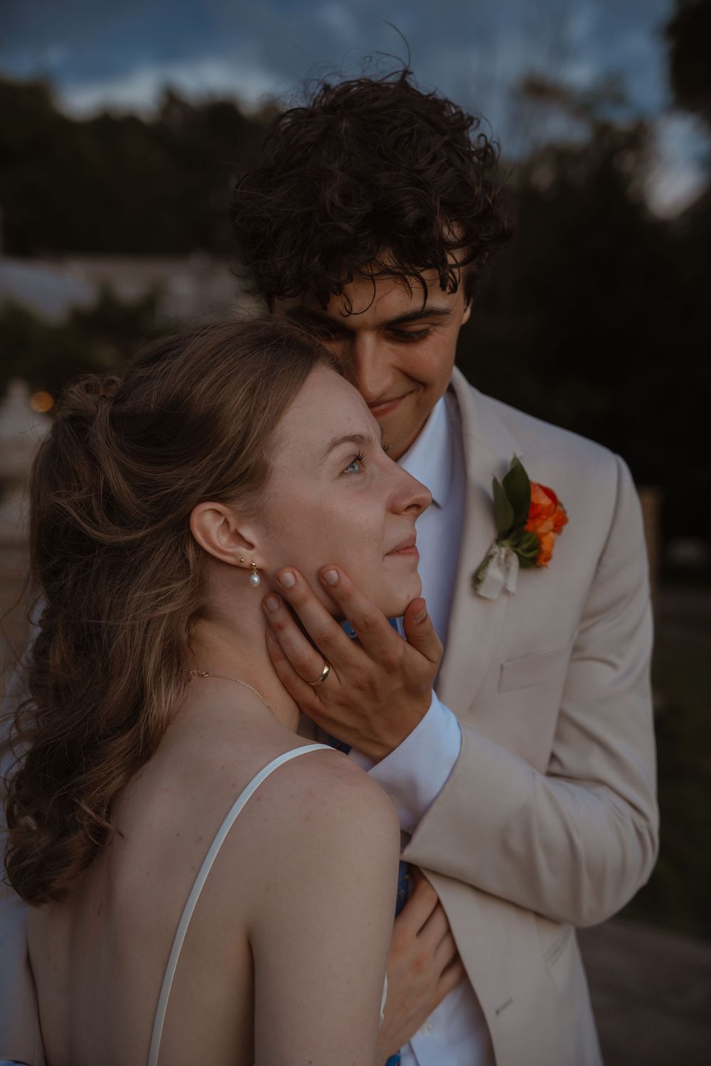 Intimate wedding portraits captured during golden hour against a scenic backdrop.