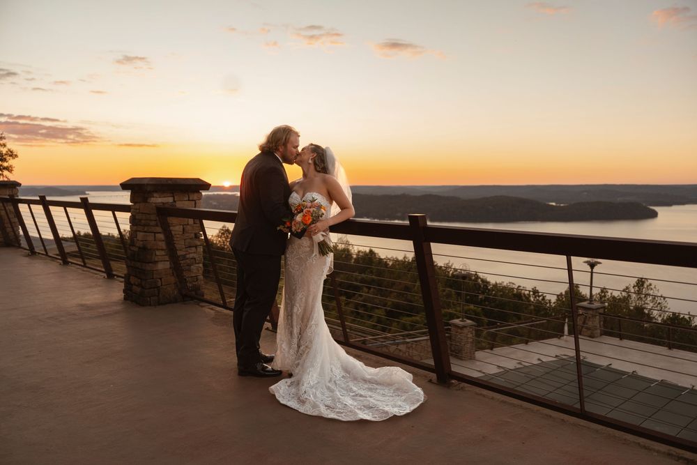 Sunset wedding photography on coastal overlook with dramatic sky.