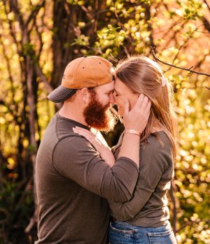 An intimate moment between a couple illuminated by golden autumn sunlight.