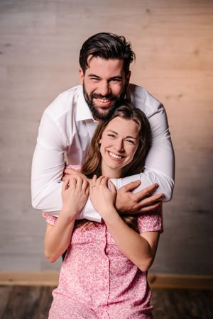 Couple shares a playful embrace and genuine laughter during their photo session.