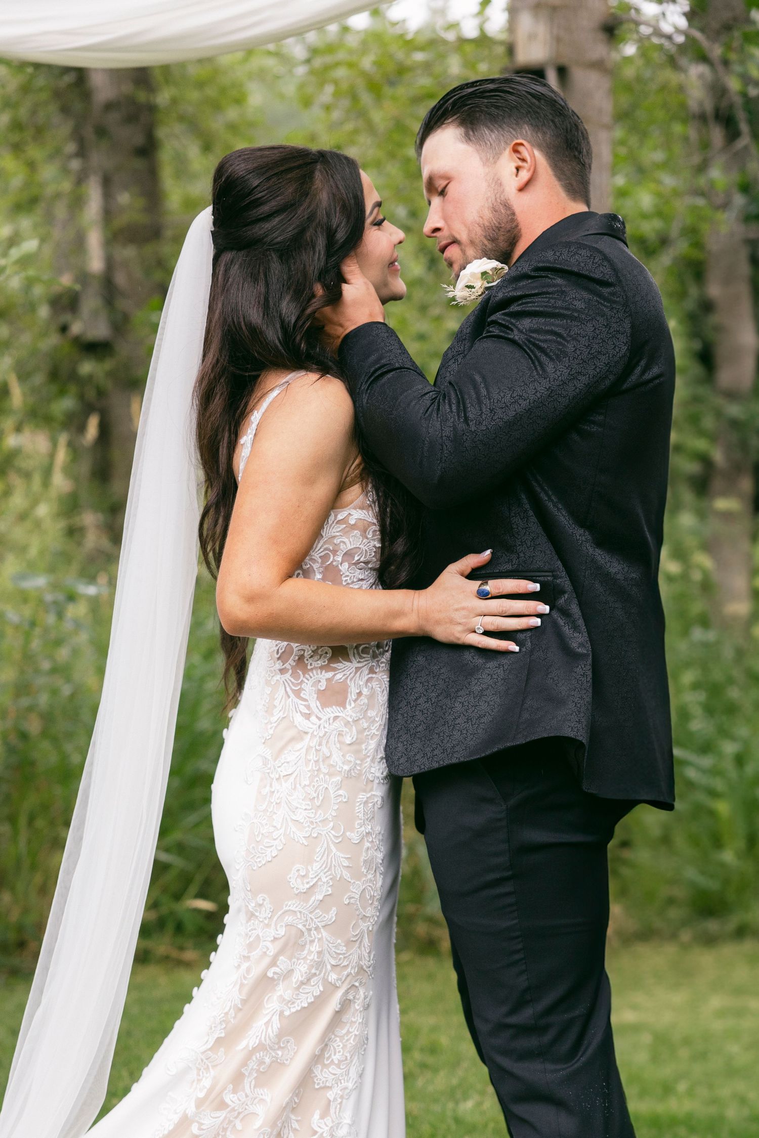 Elopement ceremony by a secluded lake in Kelowna surrounded by nature.